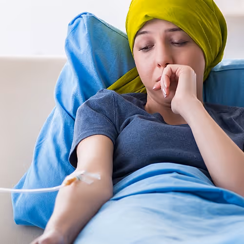 A healthcare professional monitors a patient’s hydration status during IV therapy, ensuring safe and effective support for cancer care.