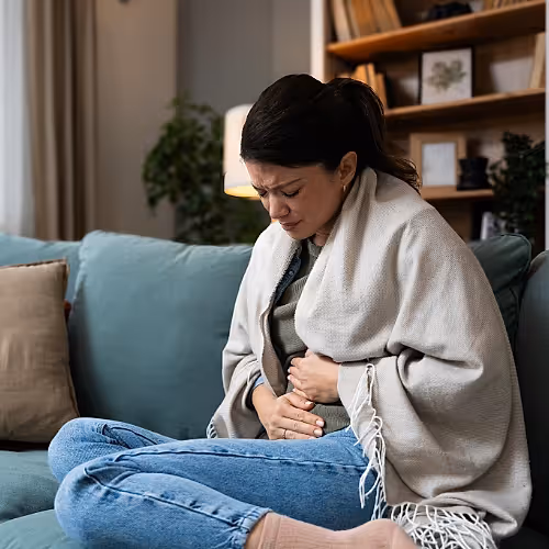 A serene setting with a patient receiving IV therapy to support irritable bowel syndrome relief.
