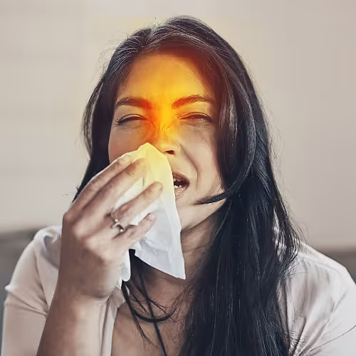 A person relaxing in a comfortable chair while receiving IV therapy to relieve sinus congestion and pressure naturally.