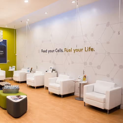Spacious wellness lounge with comfortable seating and soft lighting for client relaxation.